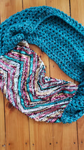 Load image into Gallery viewer, Chevron sequin scarf with stripes in turquoise, silver, pink and gold. Has a handknit scarf attached to make it one big circle scarf. 

